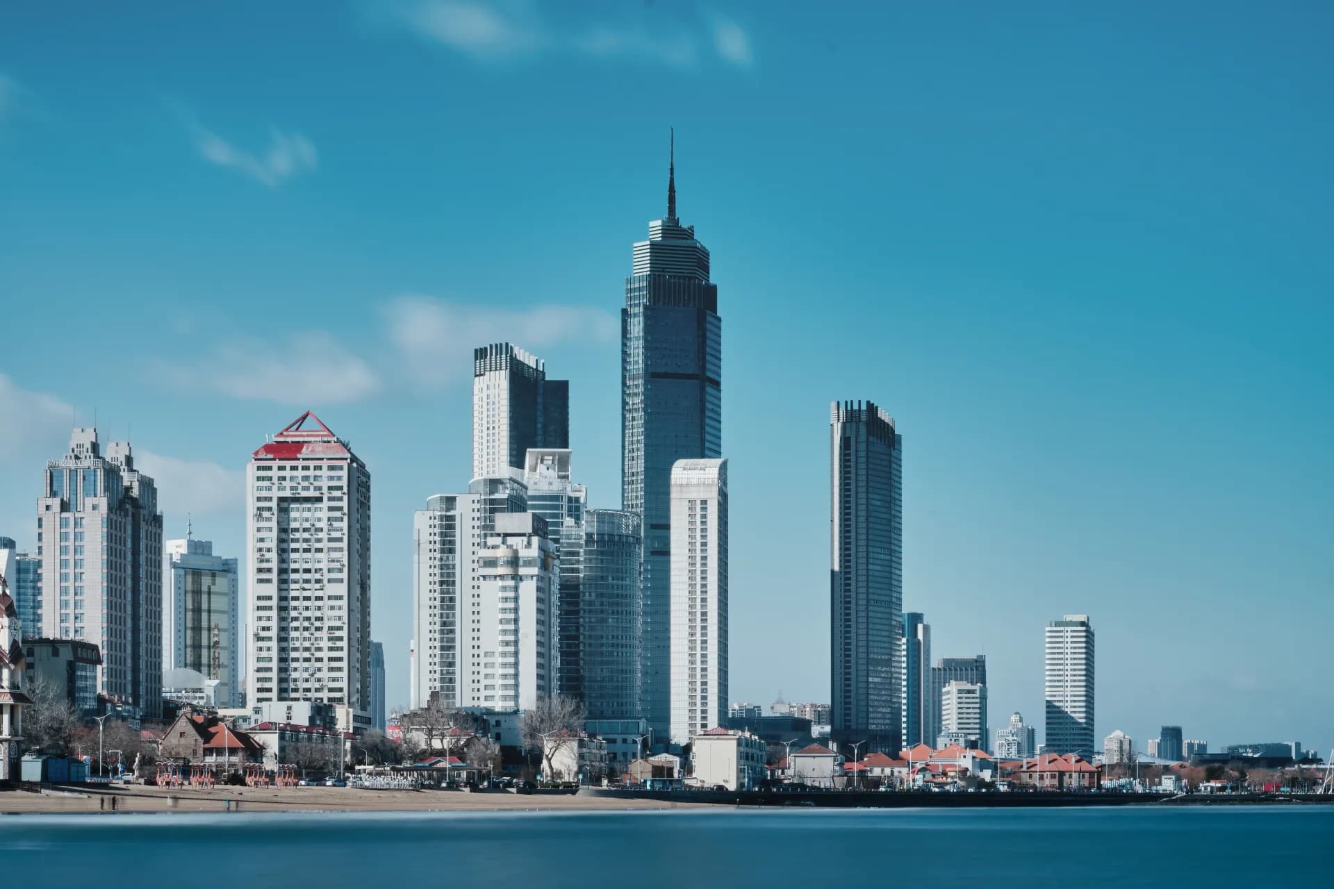 a view of a city with tall buildings and a body of water