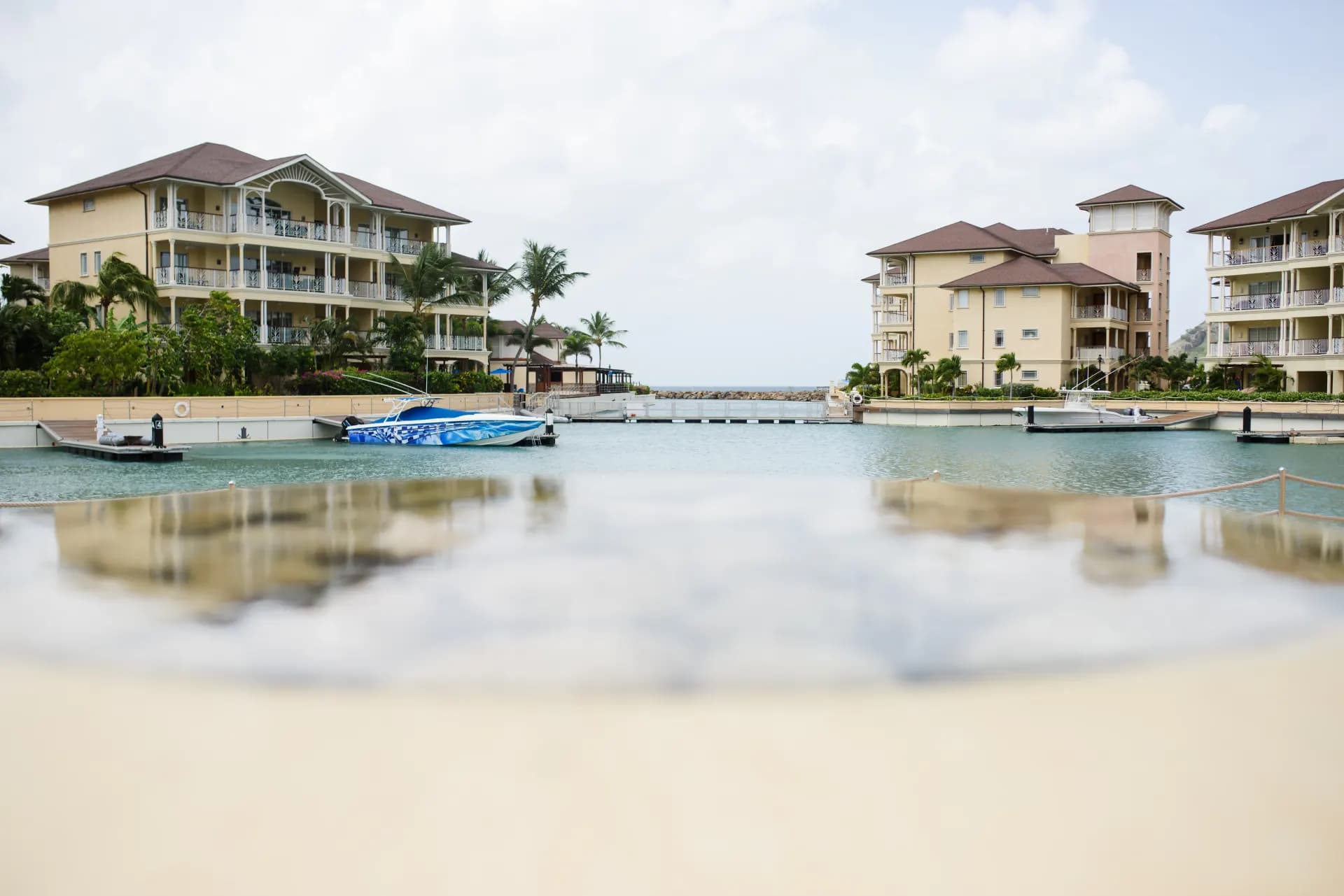 white and brown house near body of water during daytime
