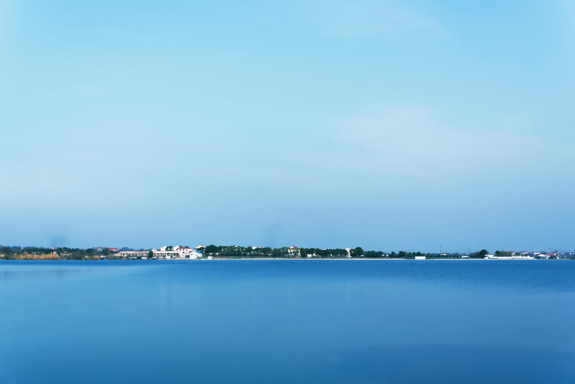 A large body of water with a sky background