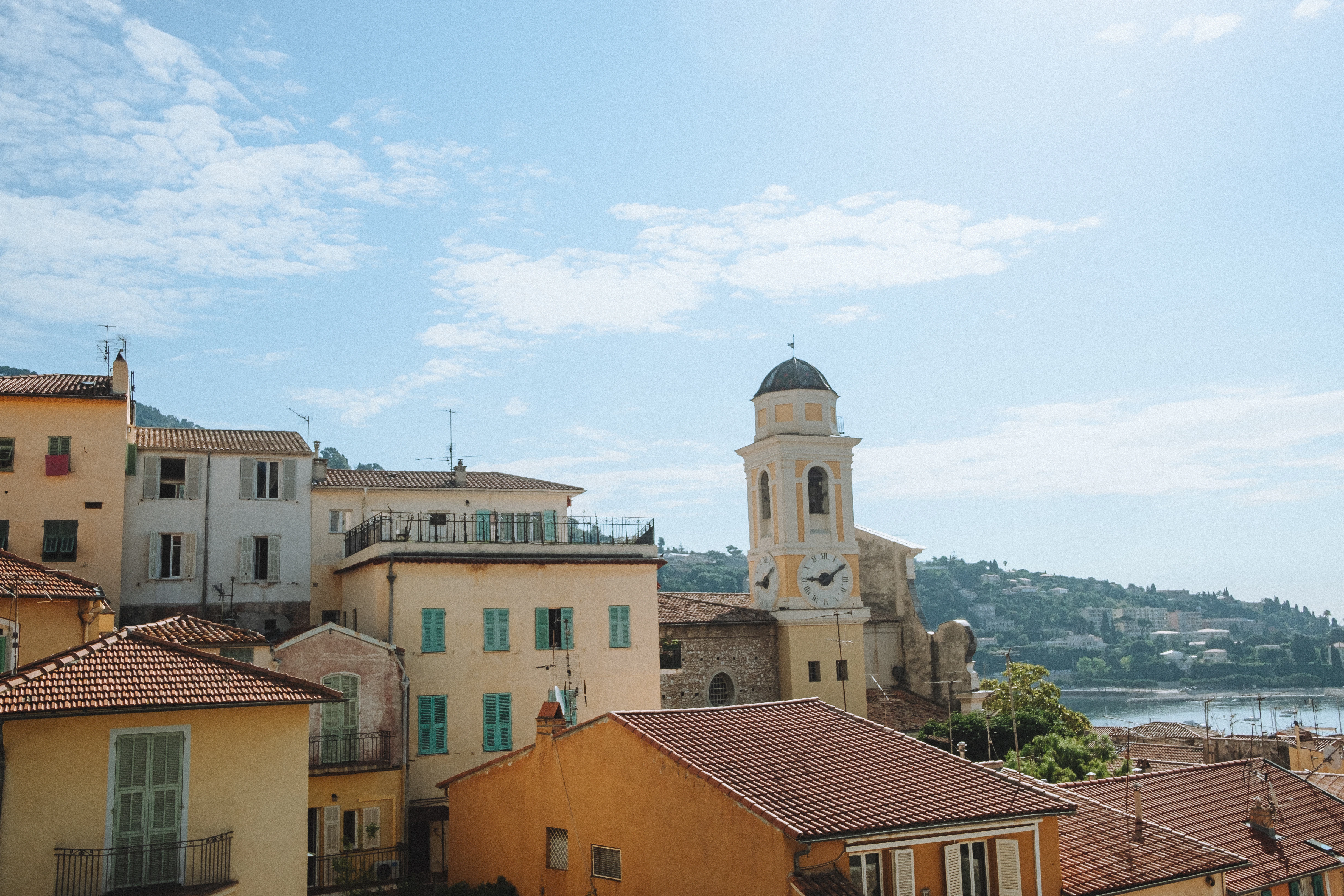 a view of some buildings and a church tower