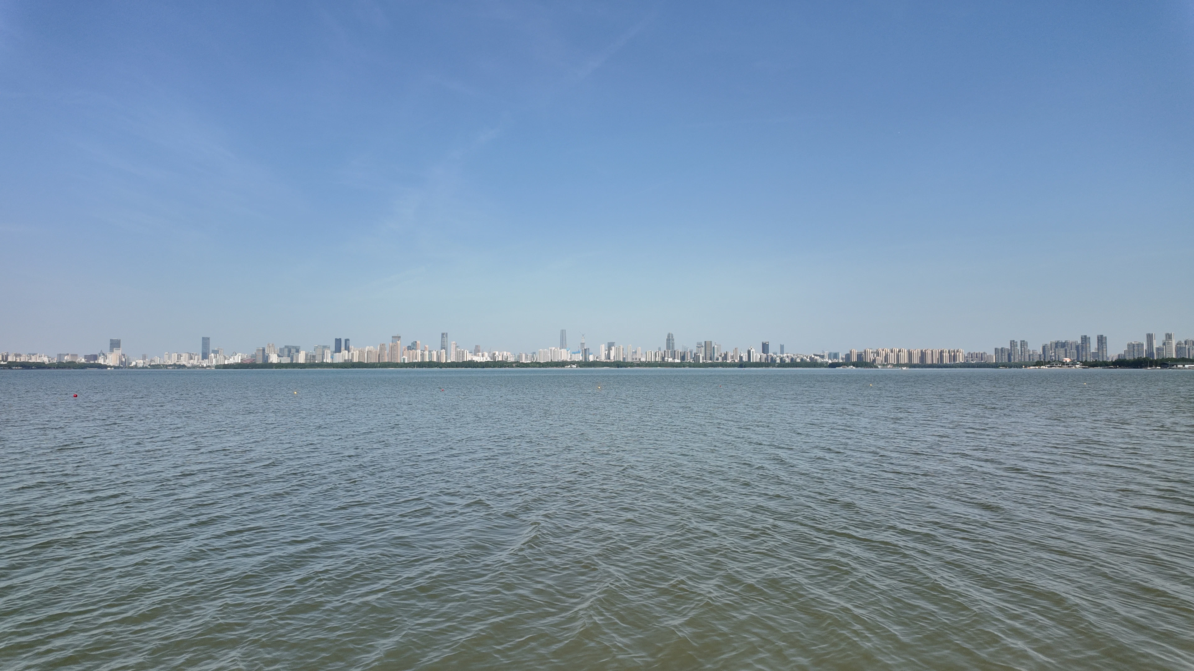 City skyline across a wide expanse of water.