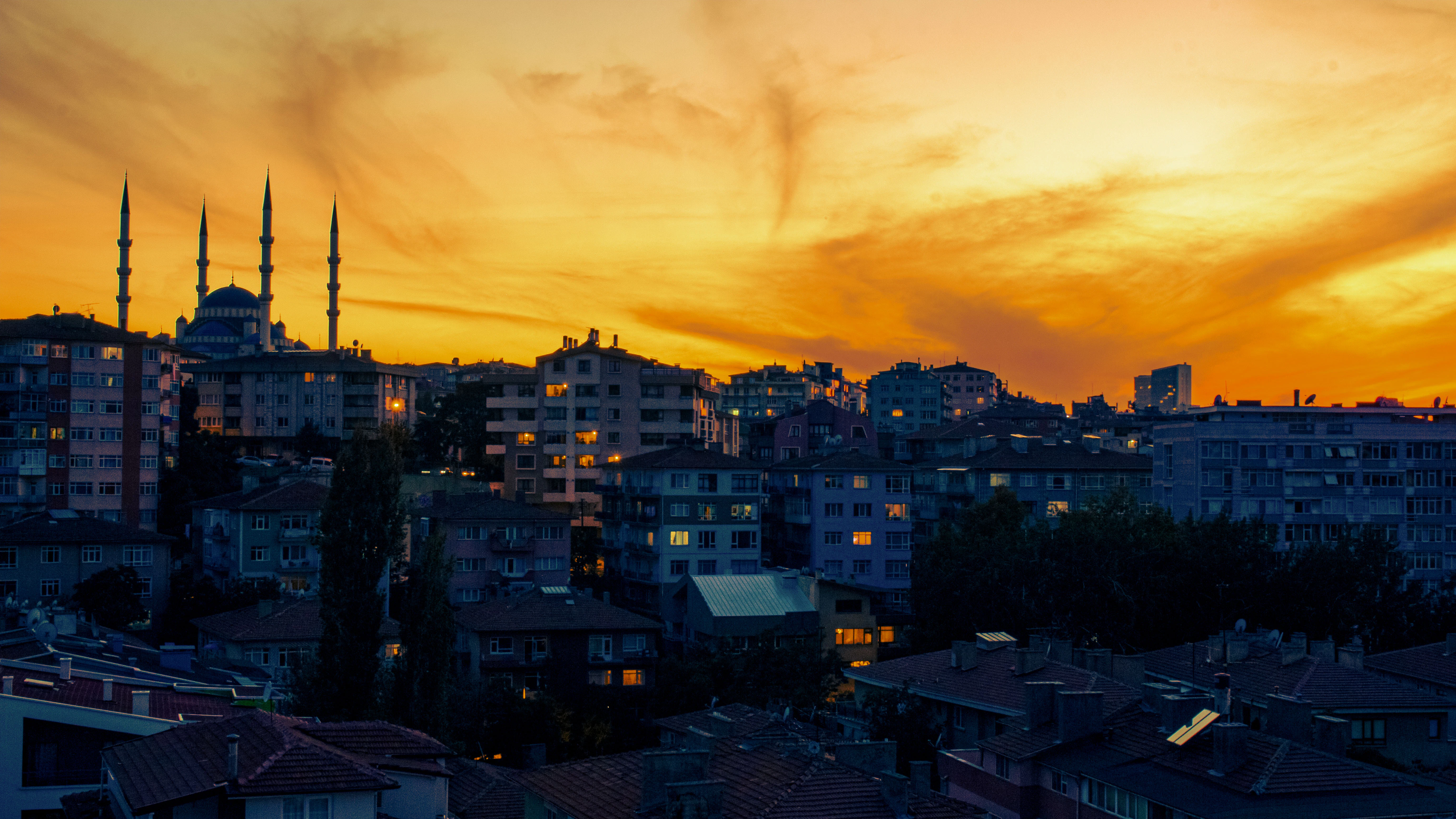 City skyline with mosque at vibrant sunset