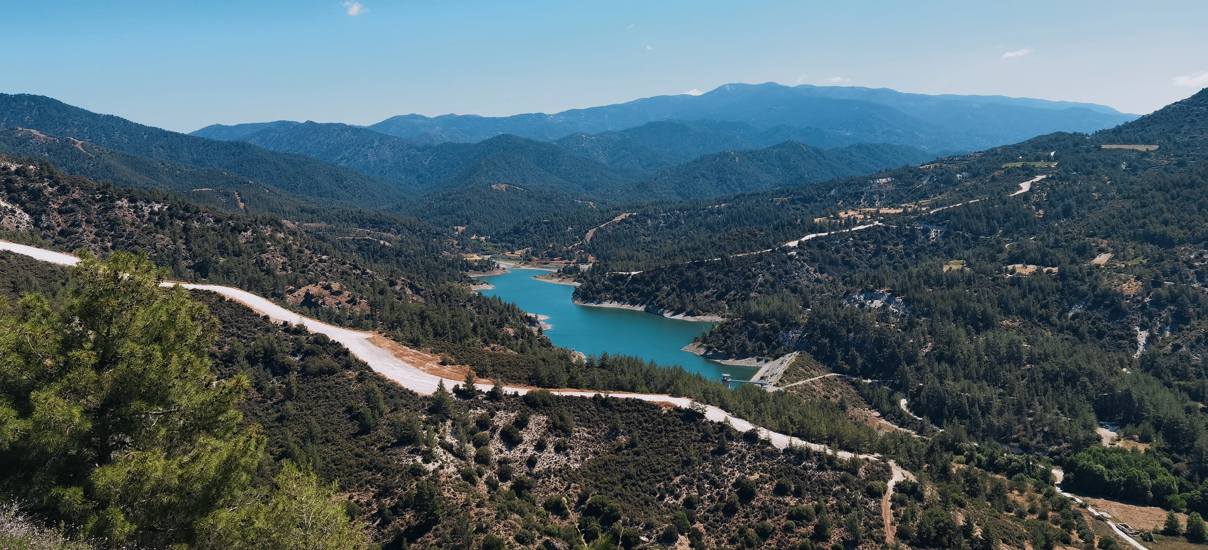 a scenic view of a lake surrounded by mountains