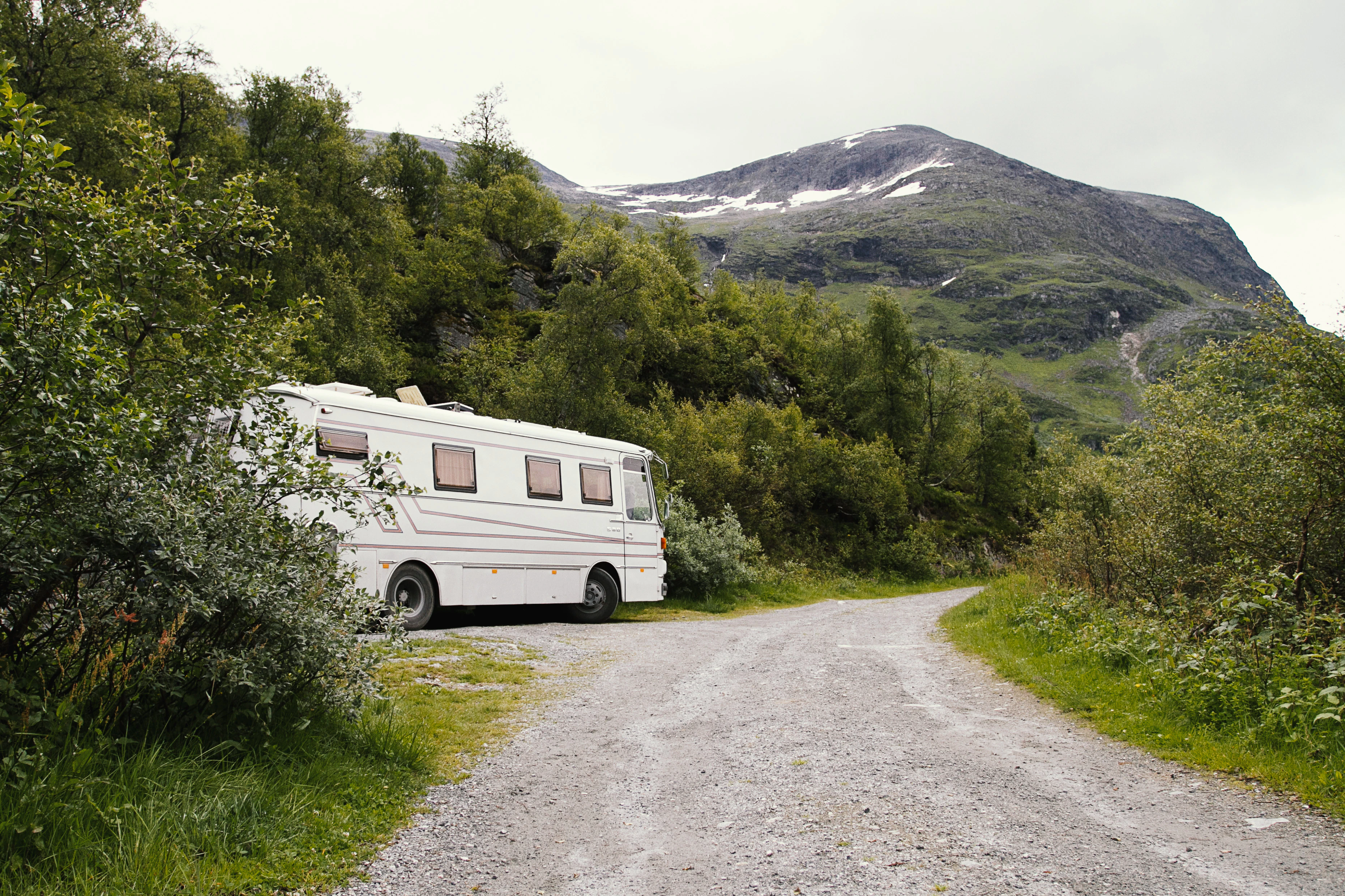 An rv parked on the side of a dirt road