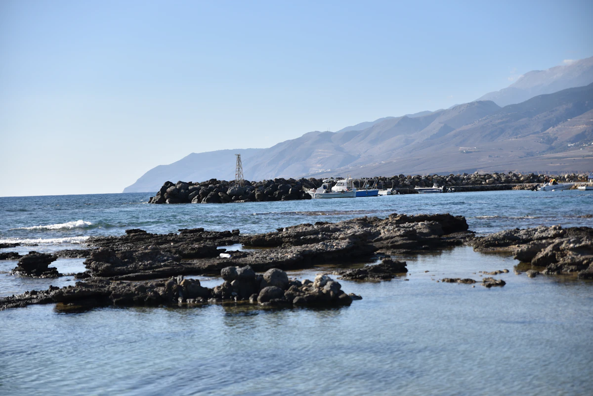 A body of water surrounded by rocks and mountains
