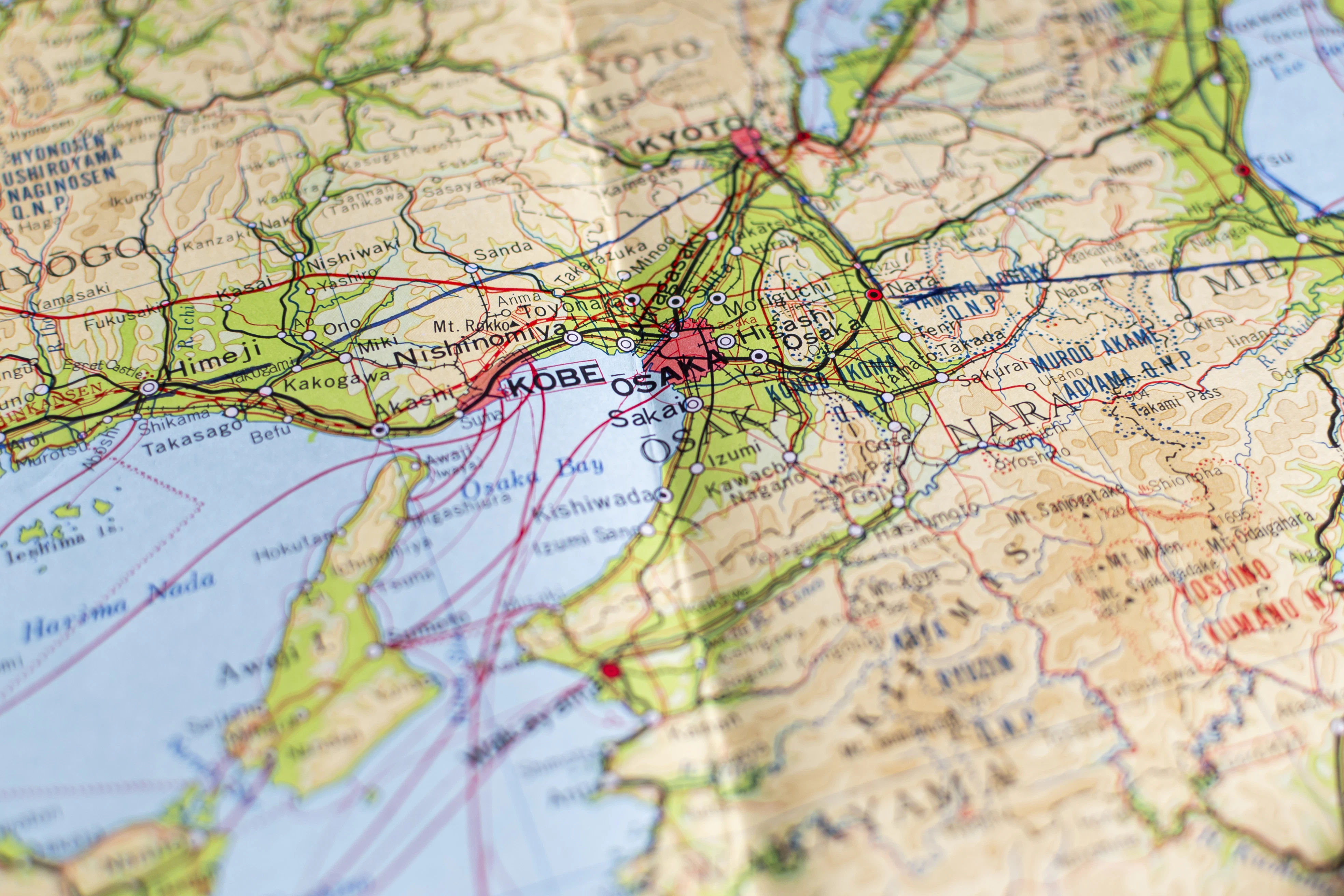 A close up of a map with a pin in it