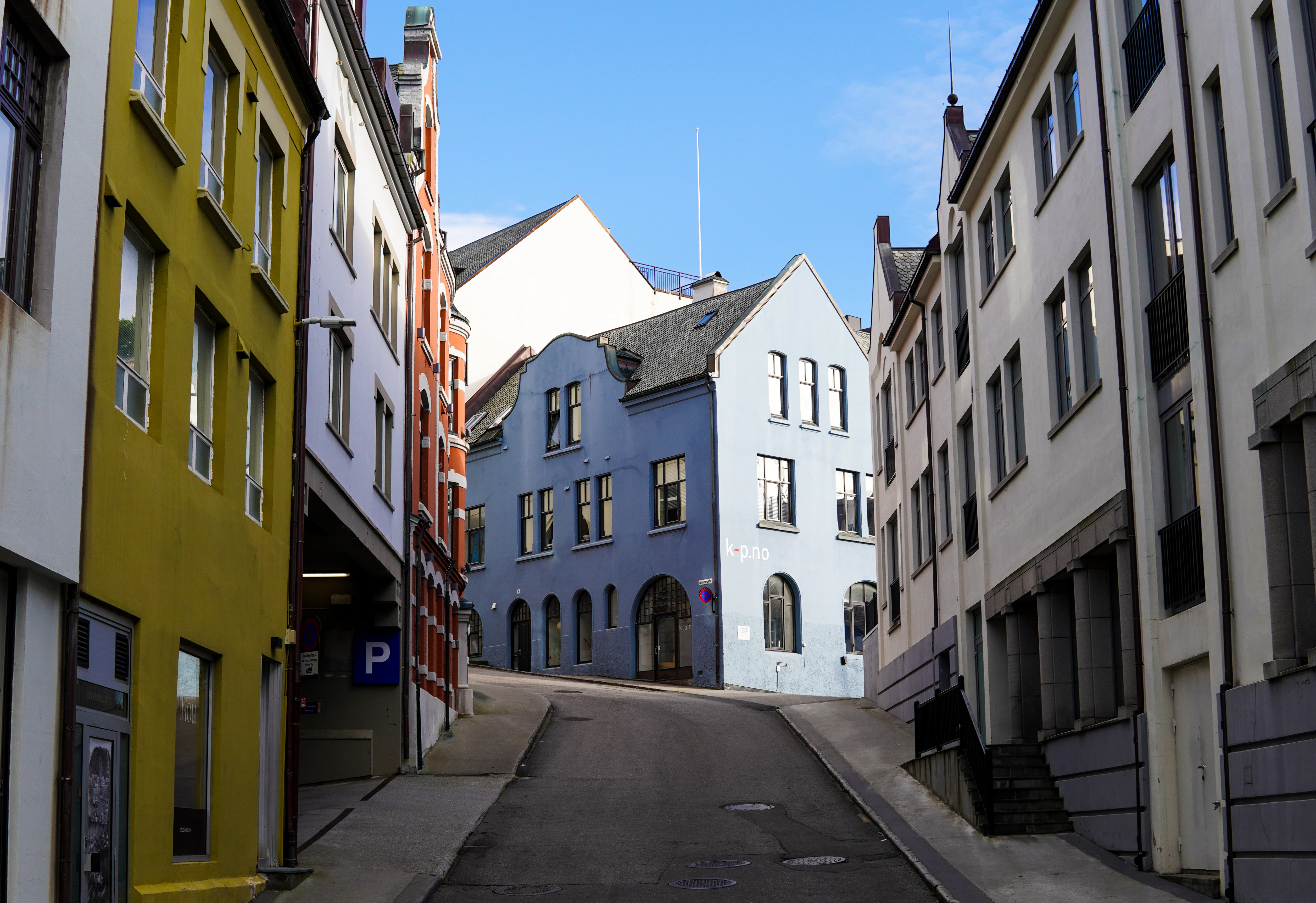 A narrow city street lined with tall buildings