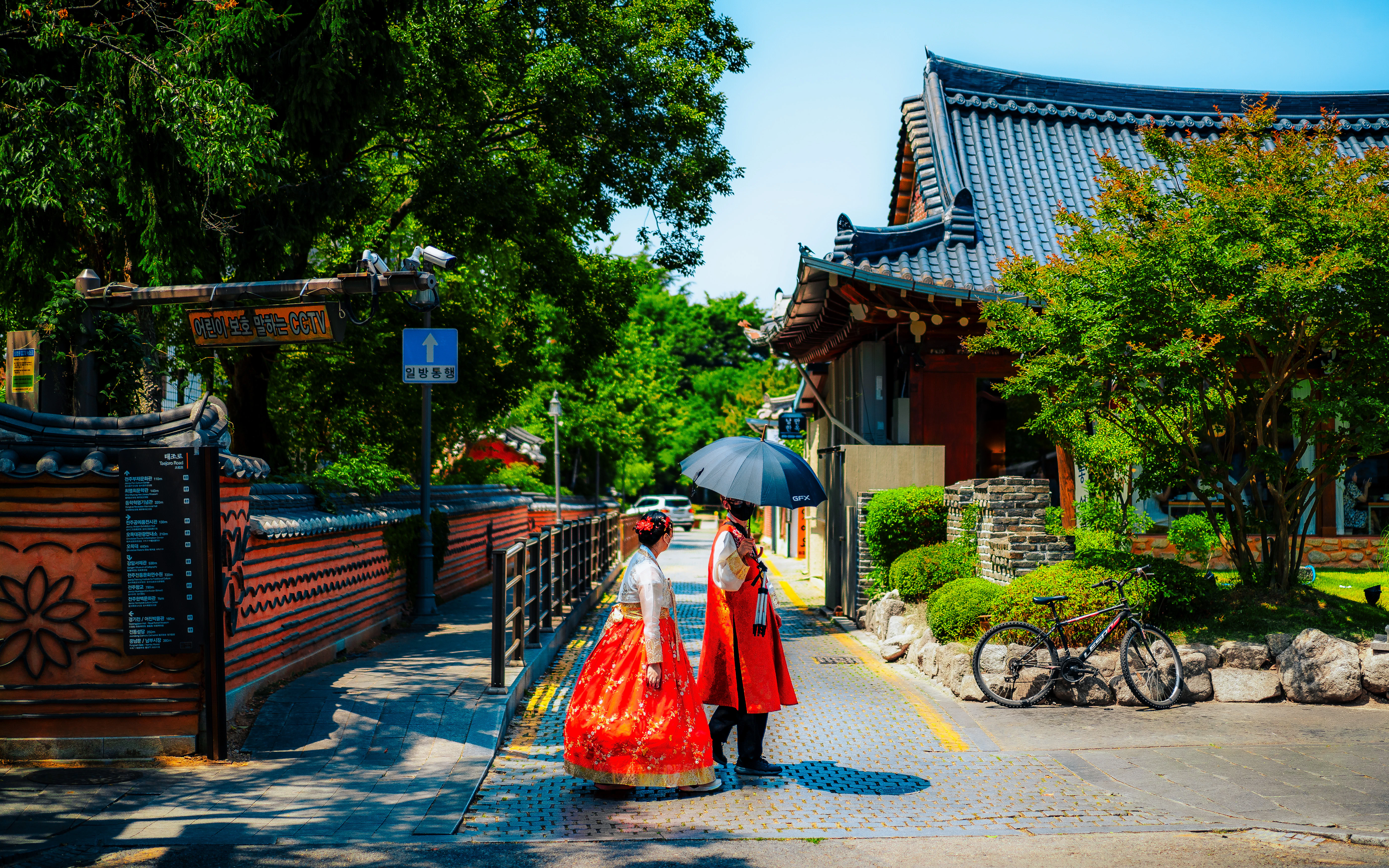 A woman walking down a street holding an umbrella