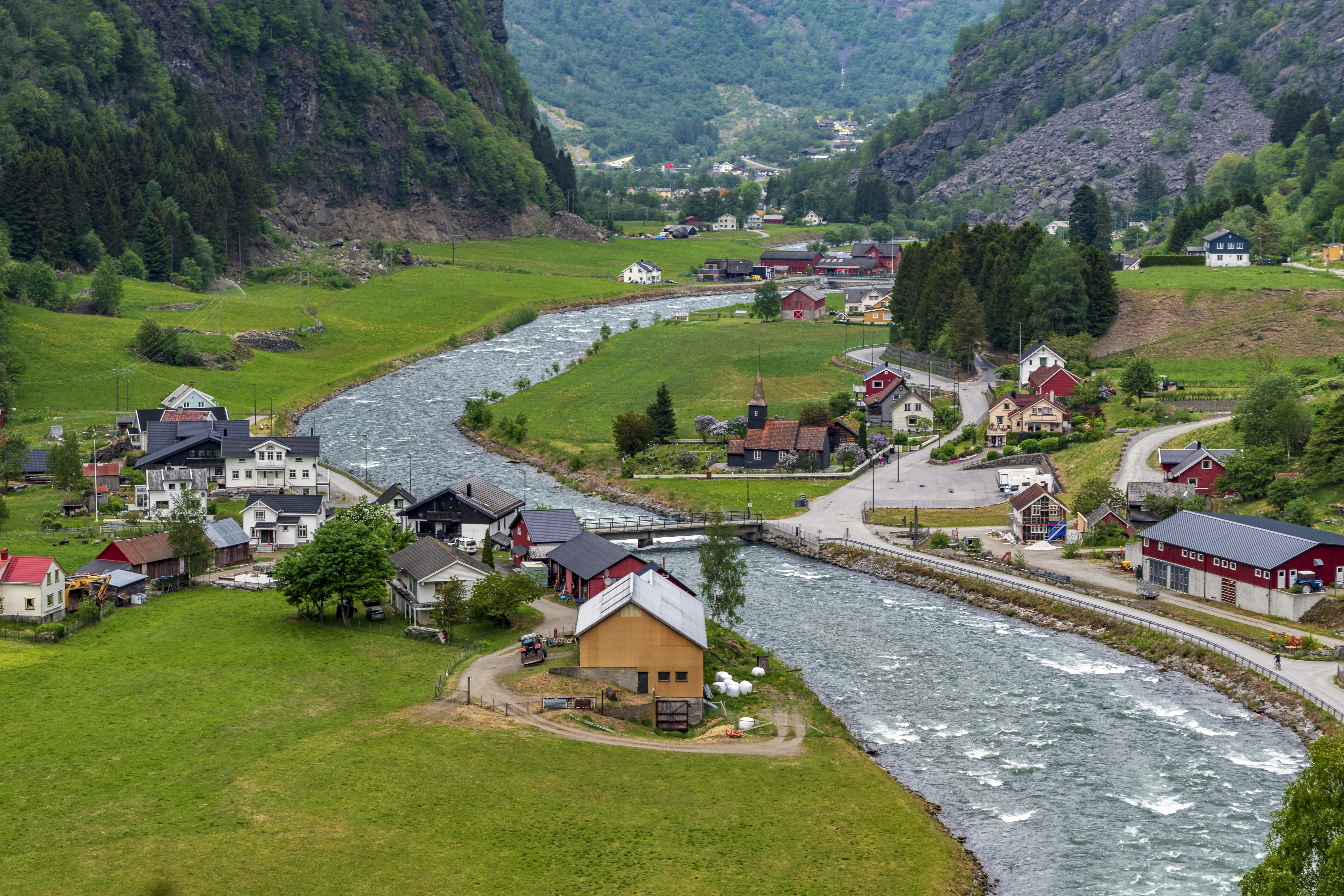 A river running through a lush green valley