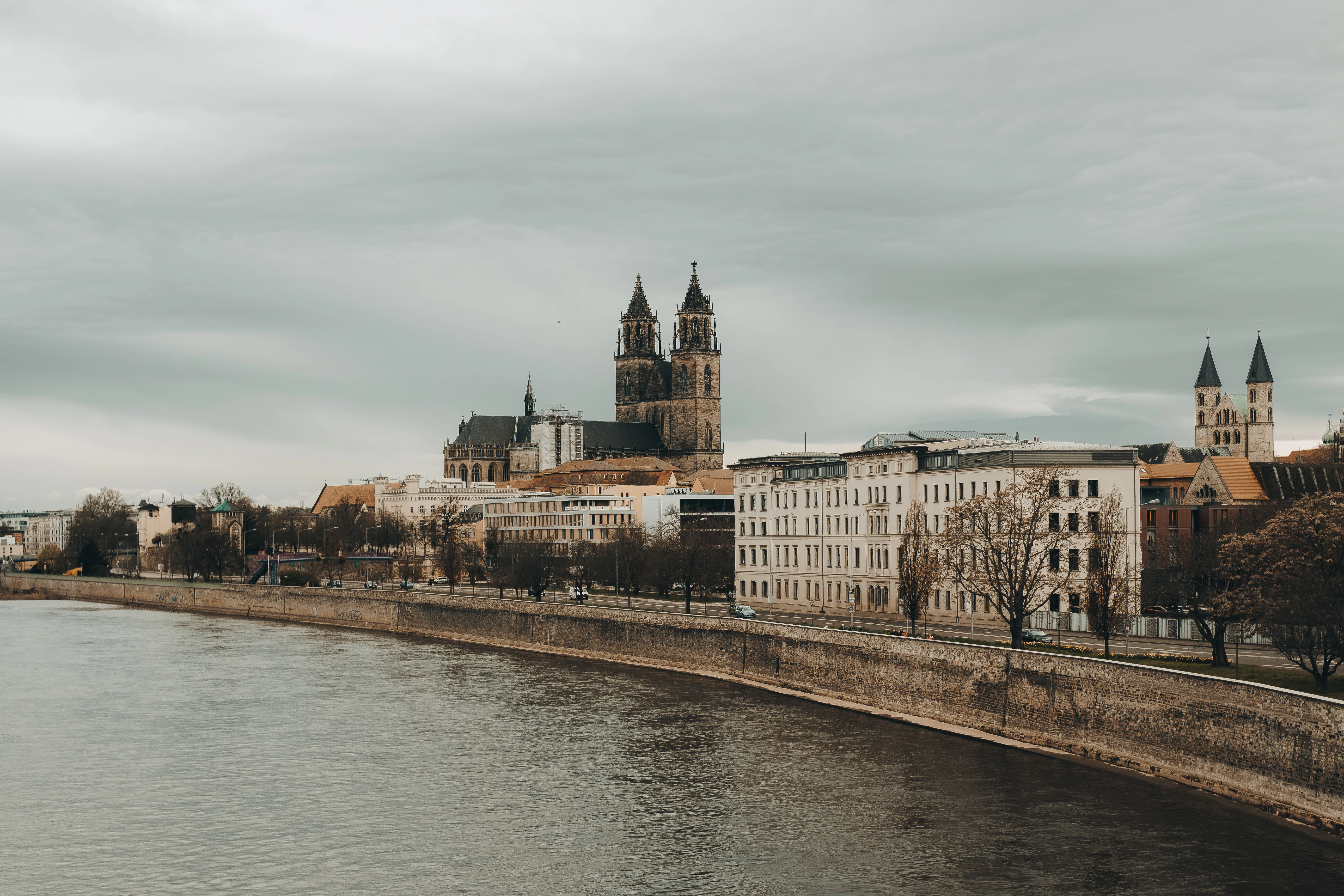 A river running through a city next to tall buildings