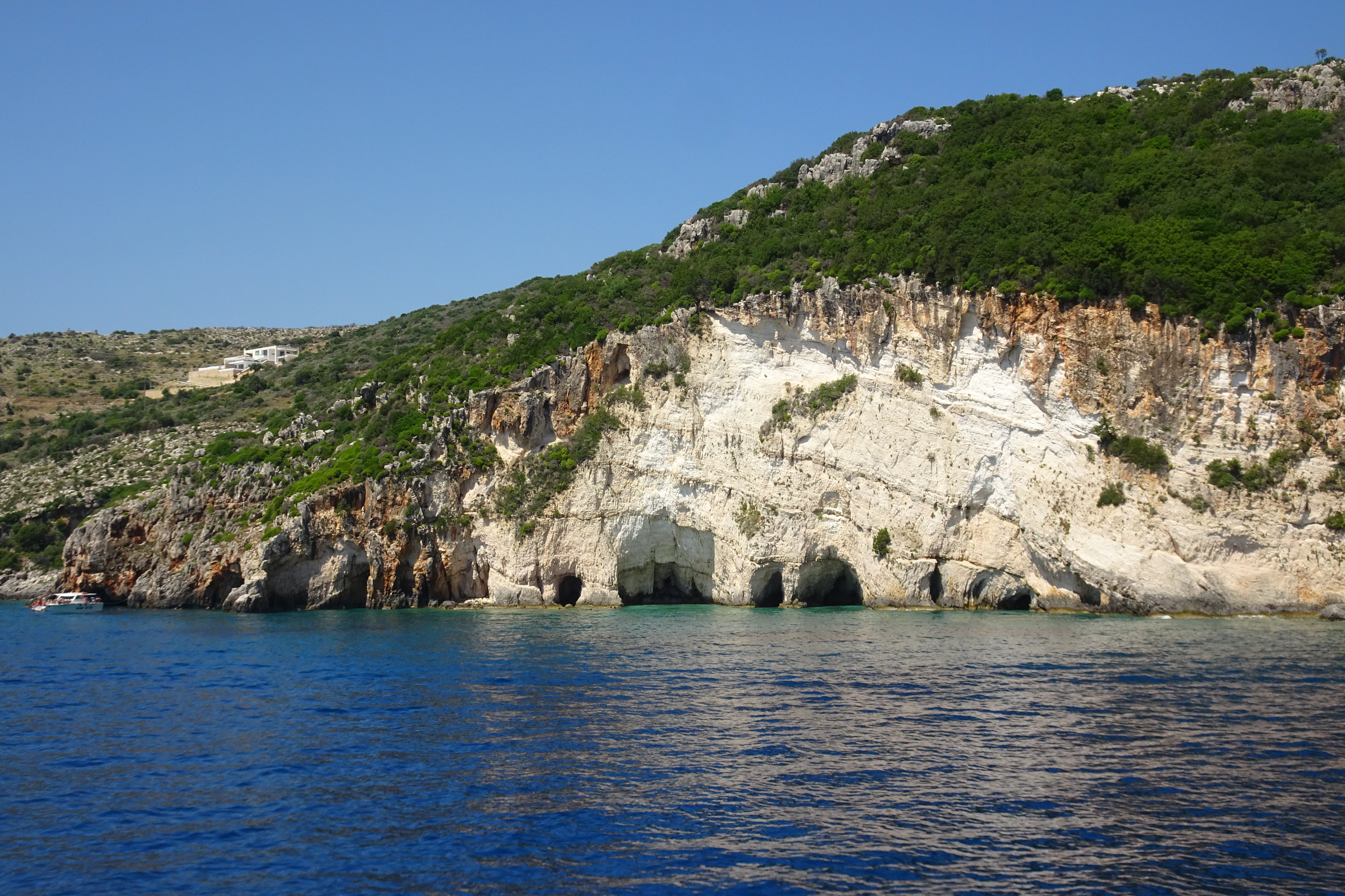 a large body of water with a mountain in the background