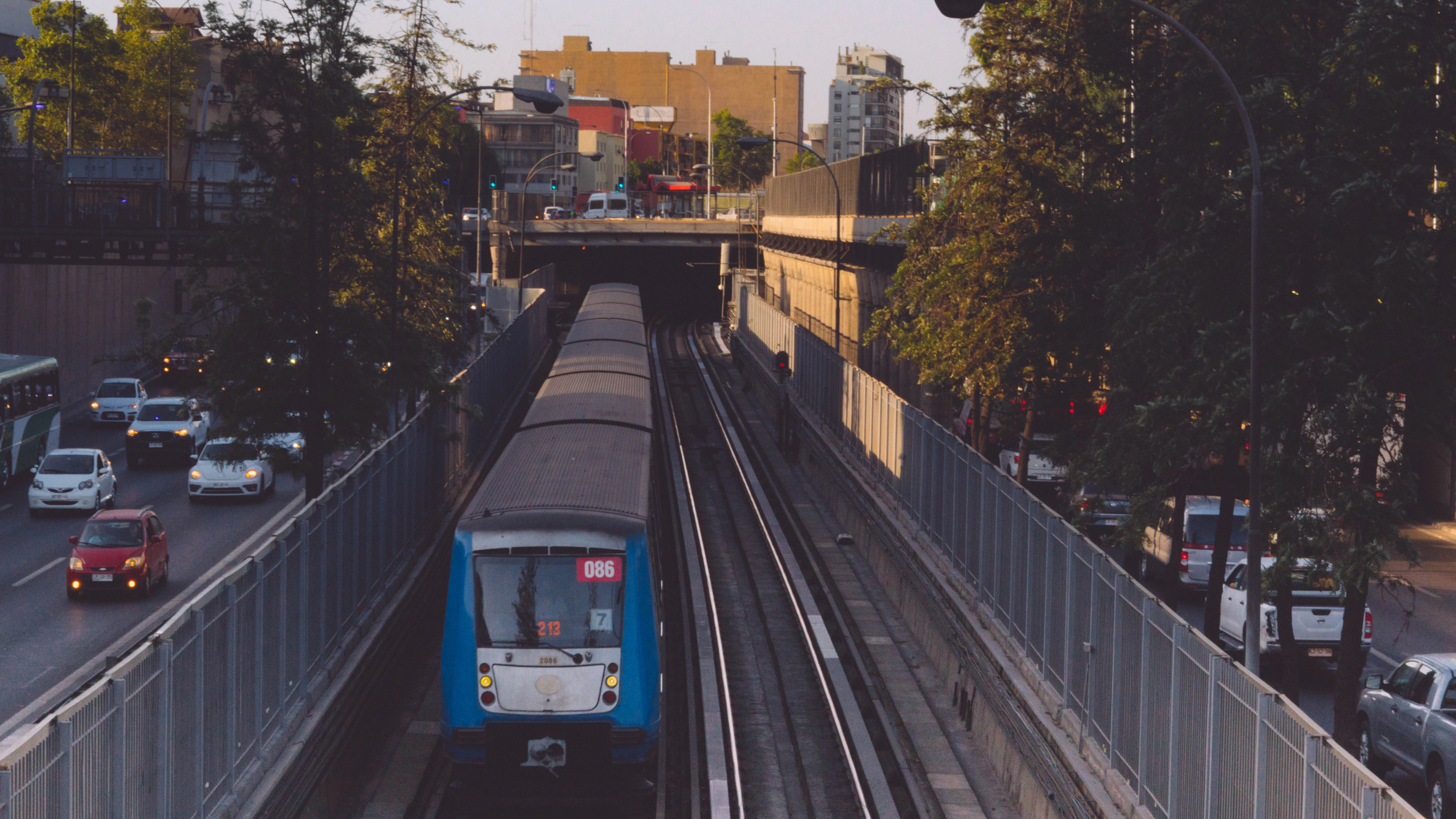 a blue and white train traveling down train tracks