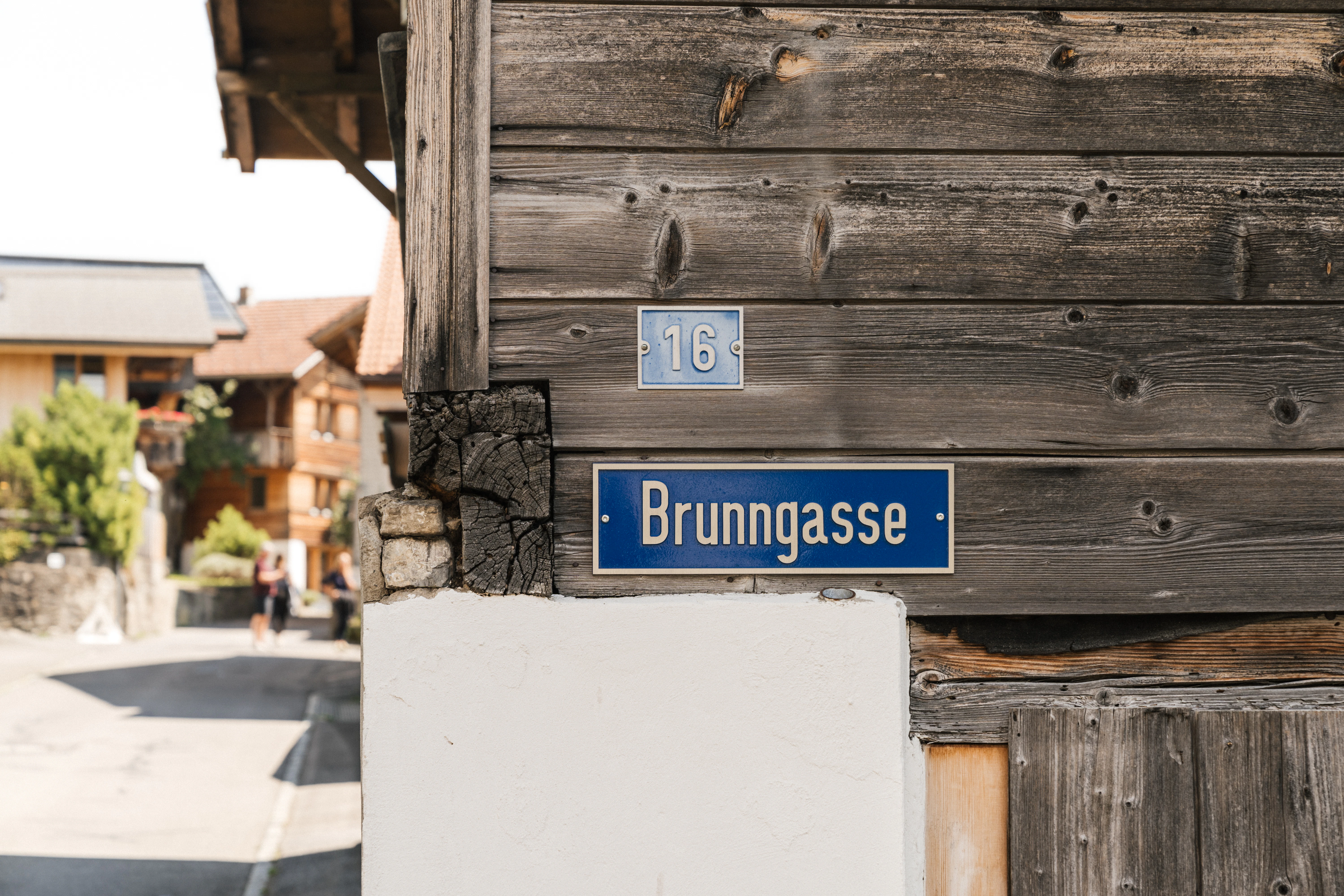 Street sign for brunngasse on a wooden building