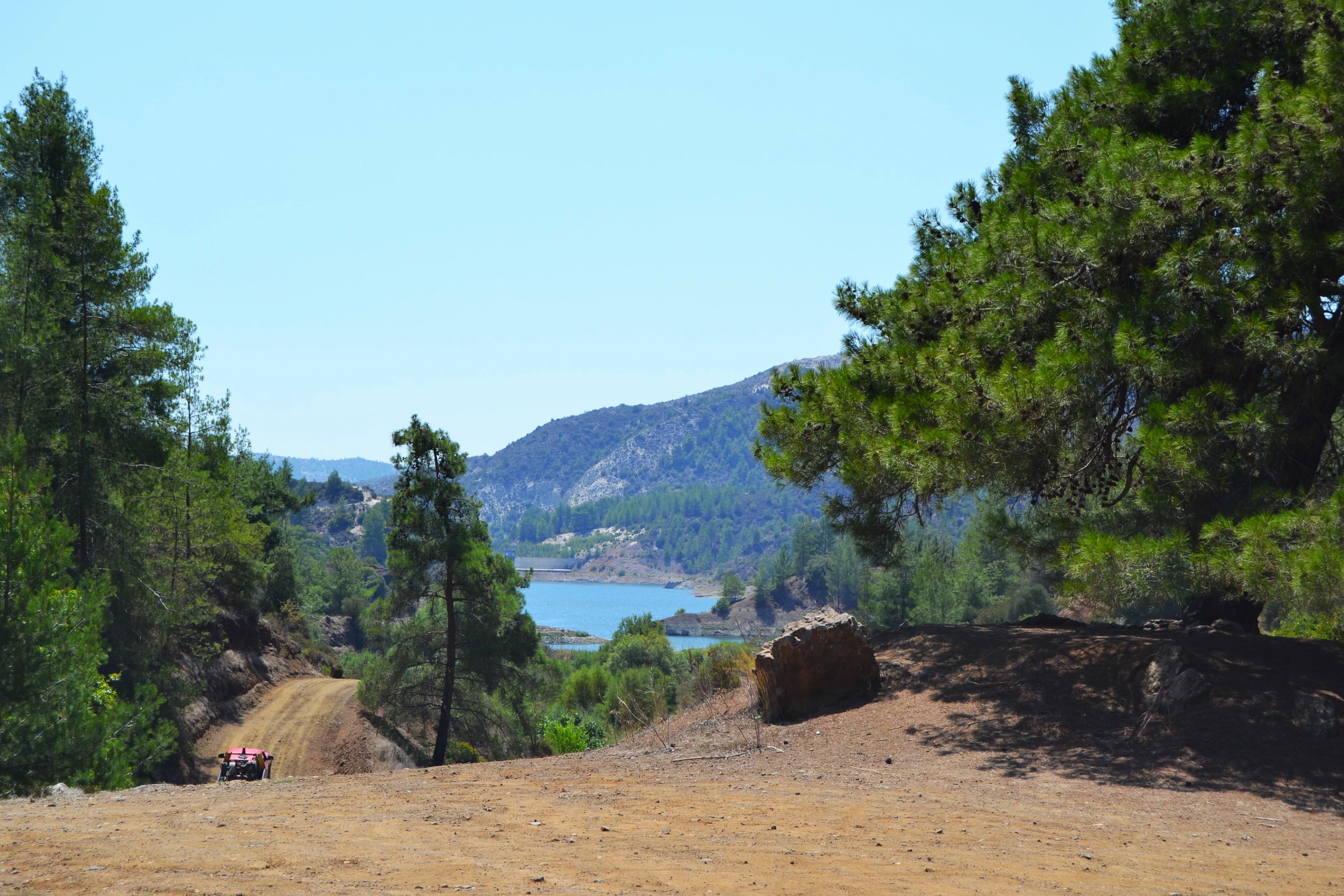A group of people riding horses down a dirt road
