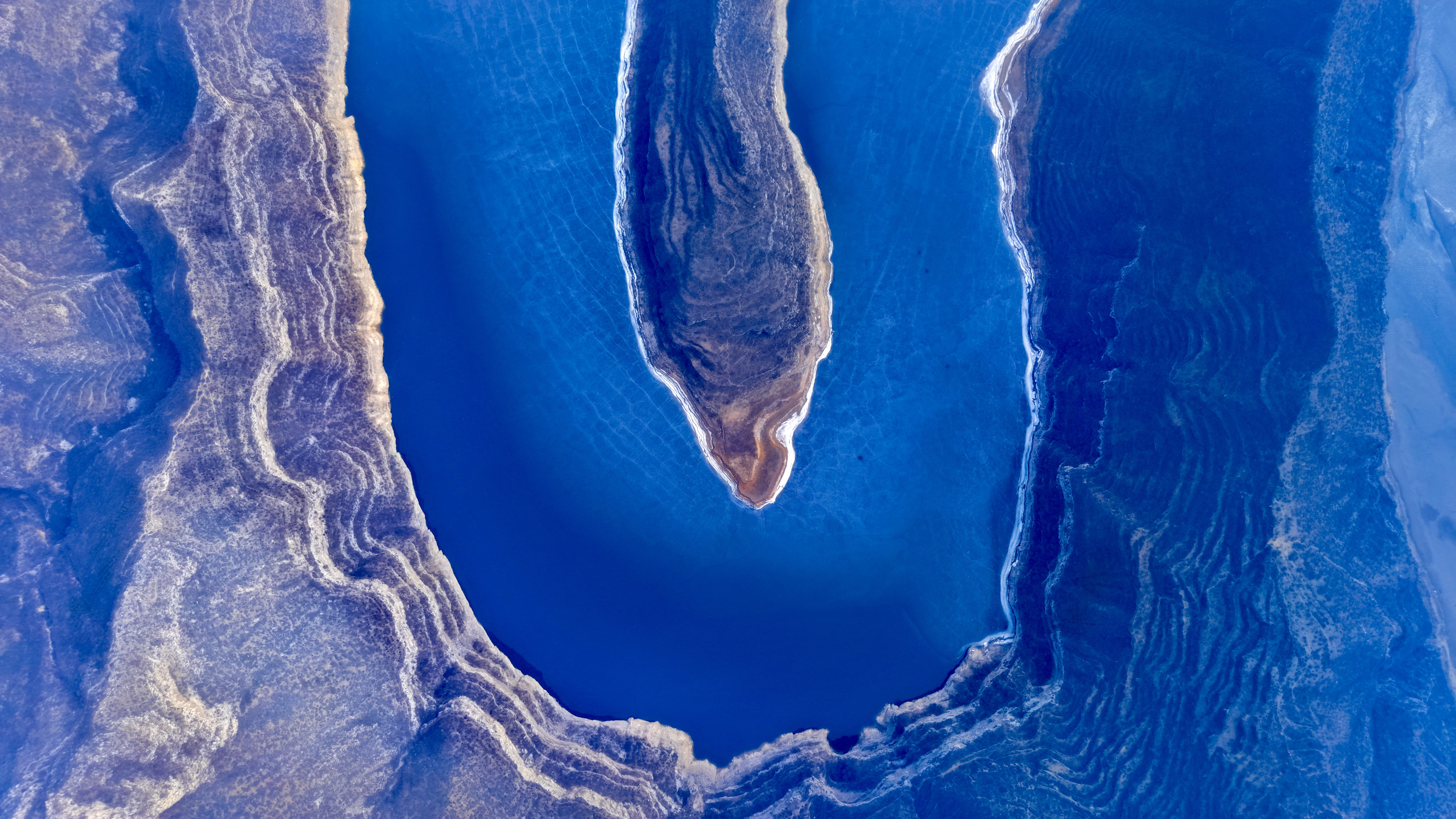 A blue lake with unique geological formations.