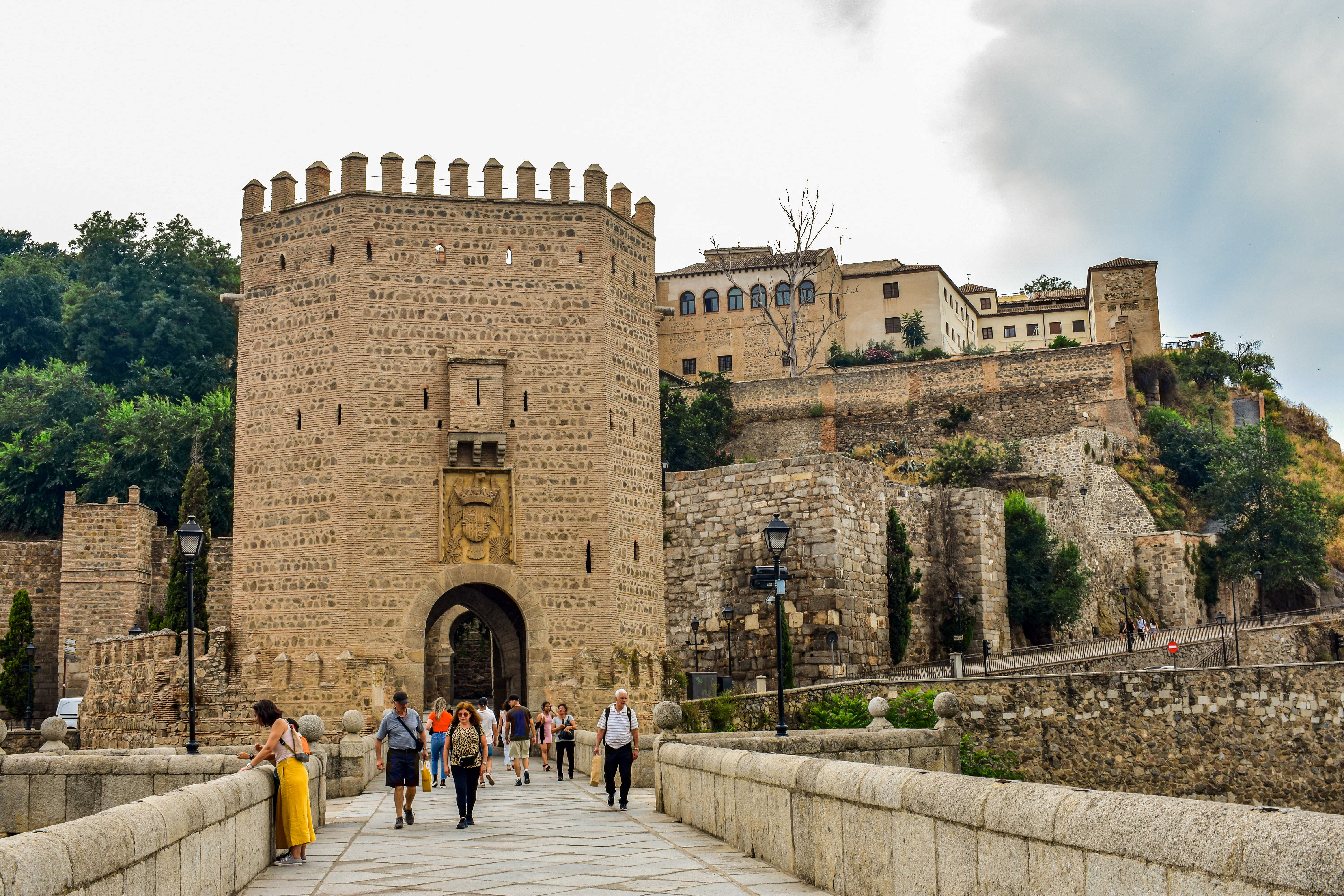 A group of people walking across a bridge