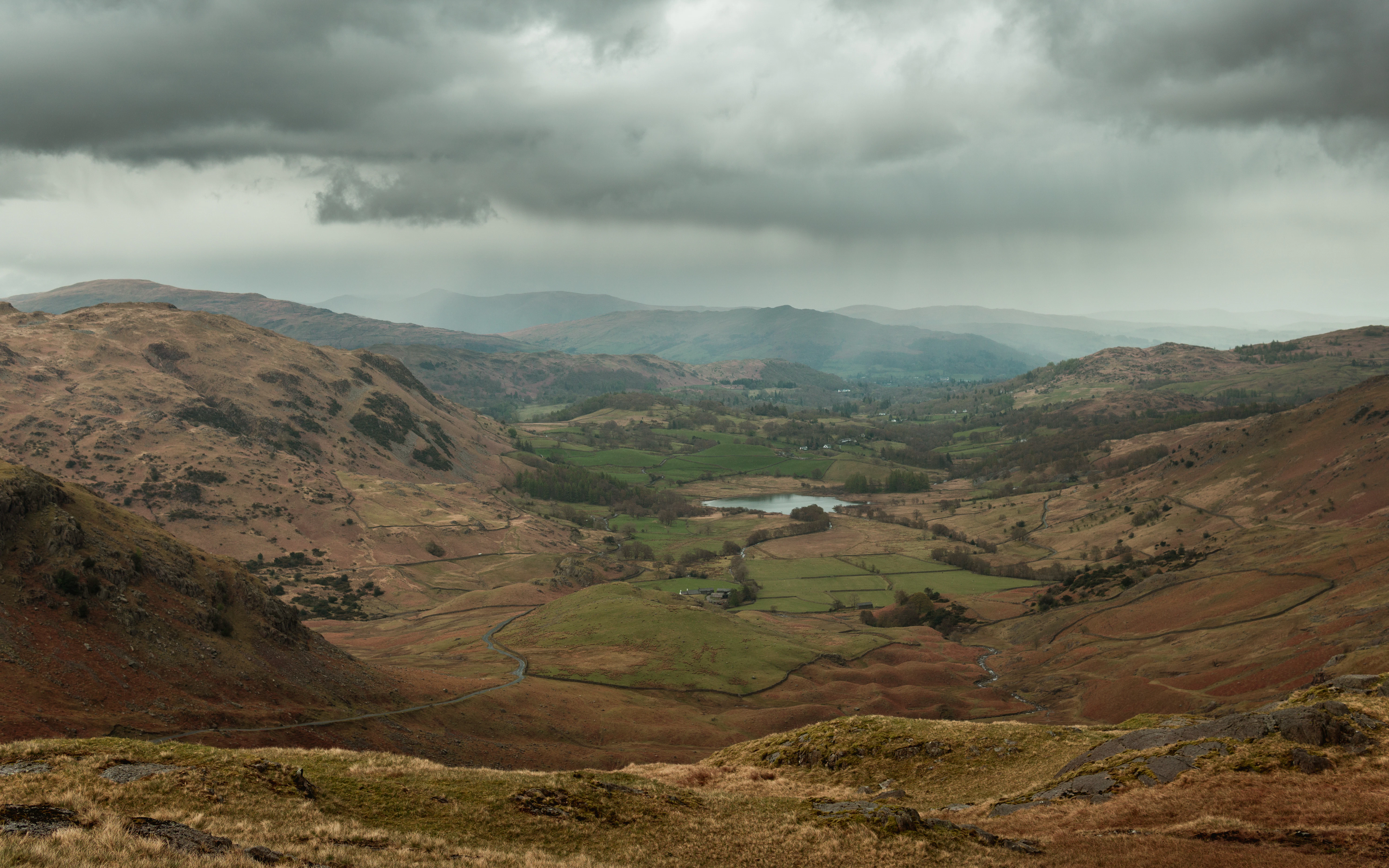a view of a valley with a lake in the middle