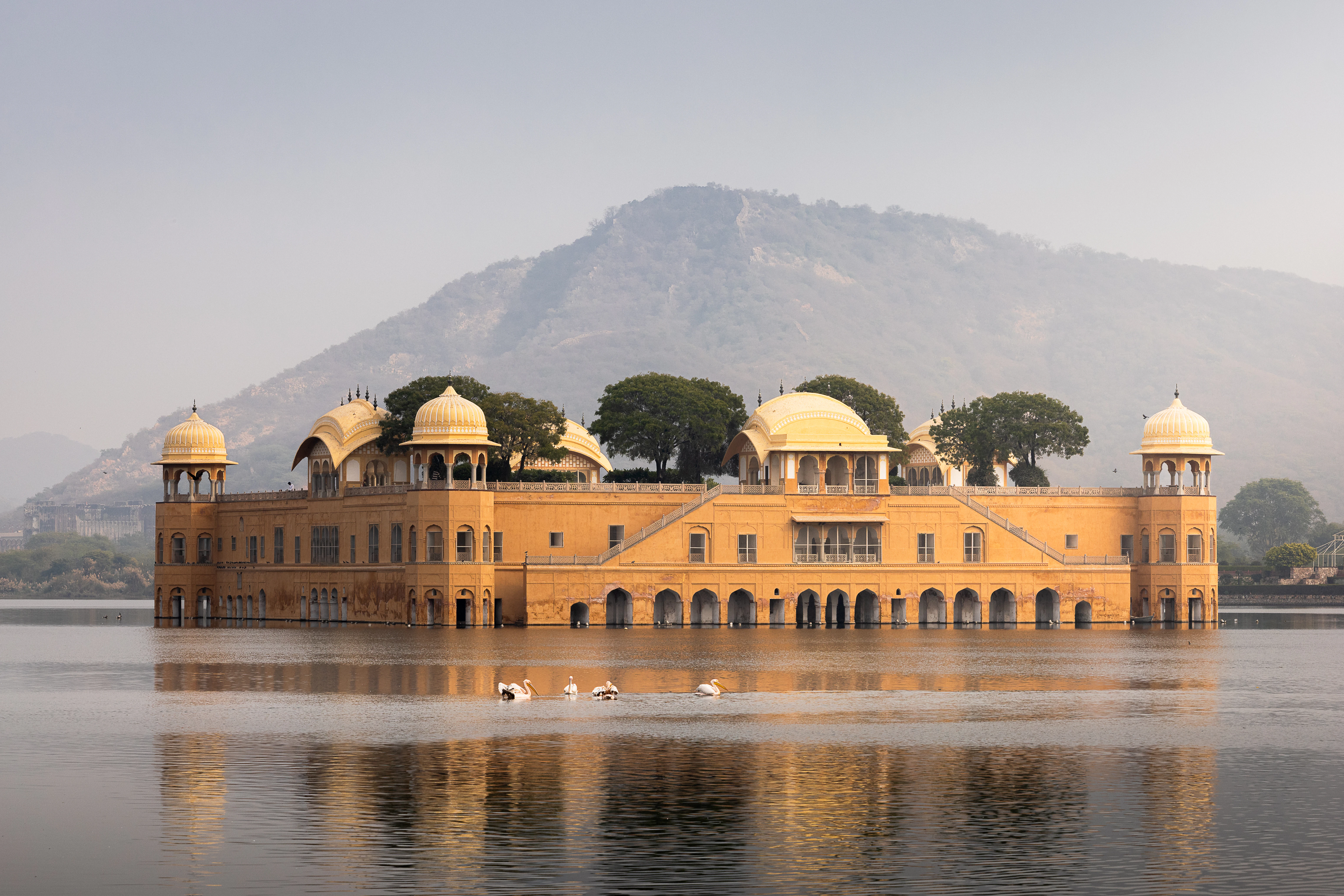 A beautiful palace floats peacefully in the water.