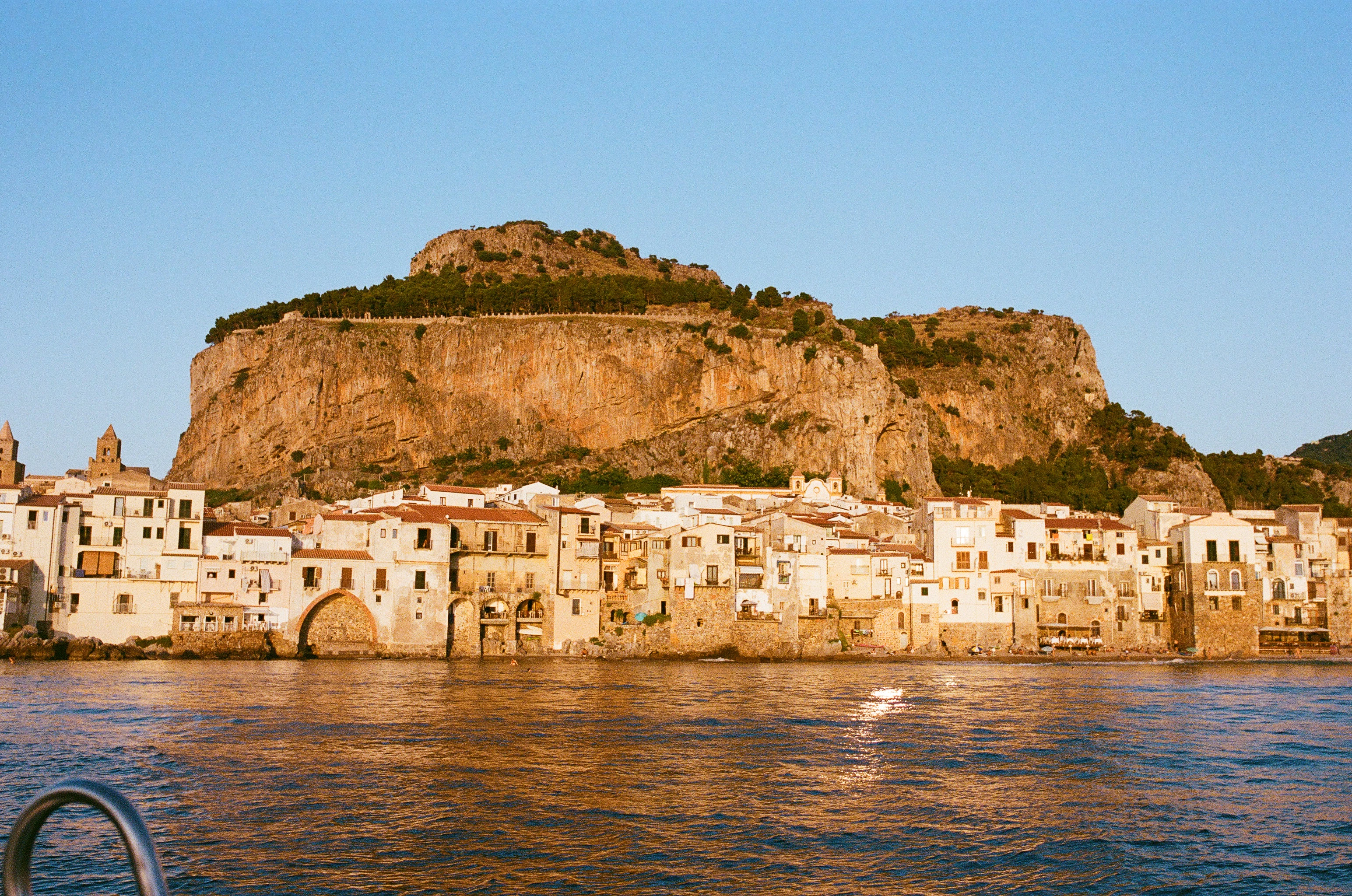 Coastal town with a large cliff behind it