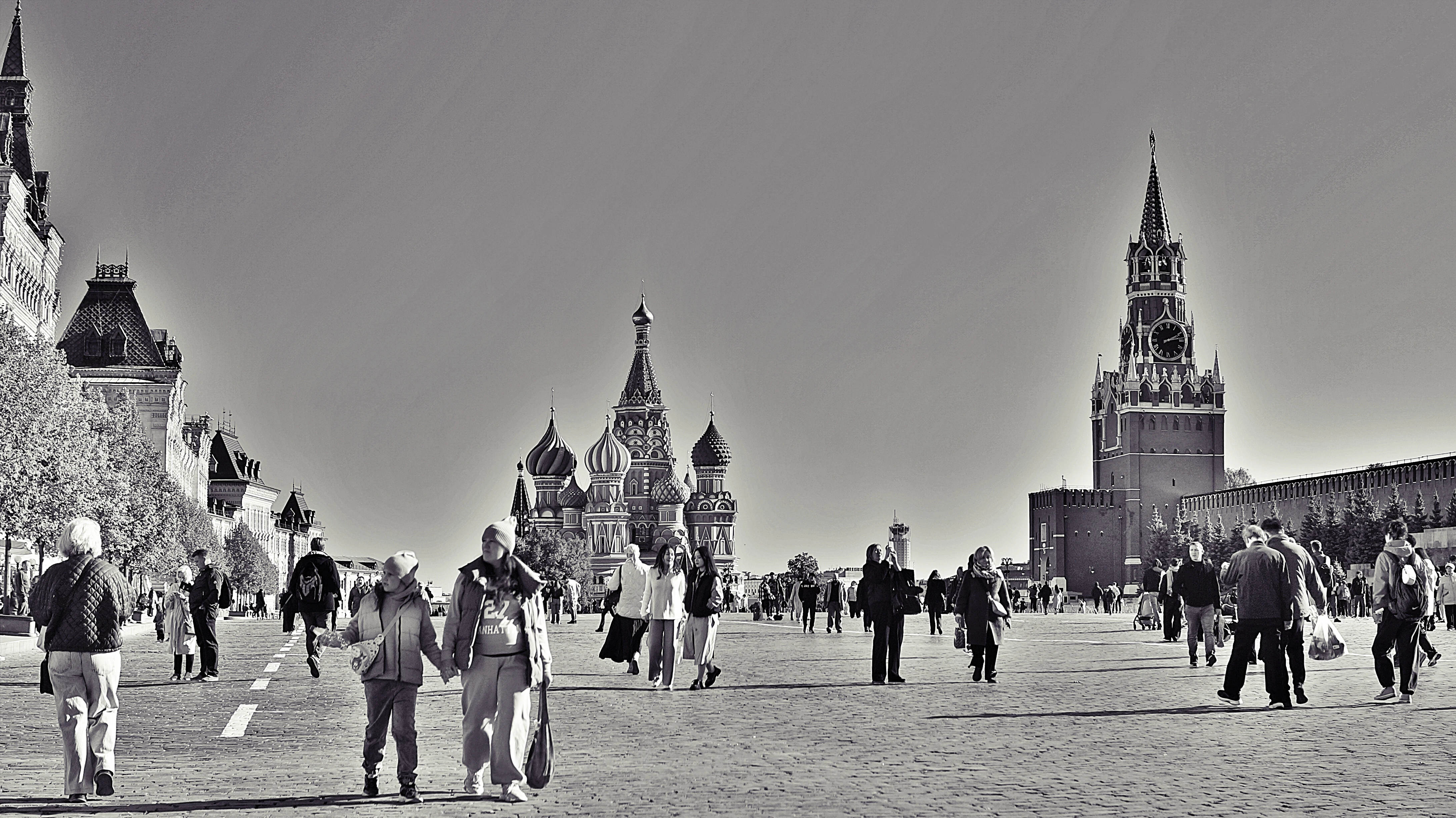 People walking in a large square with historic buildings