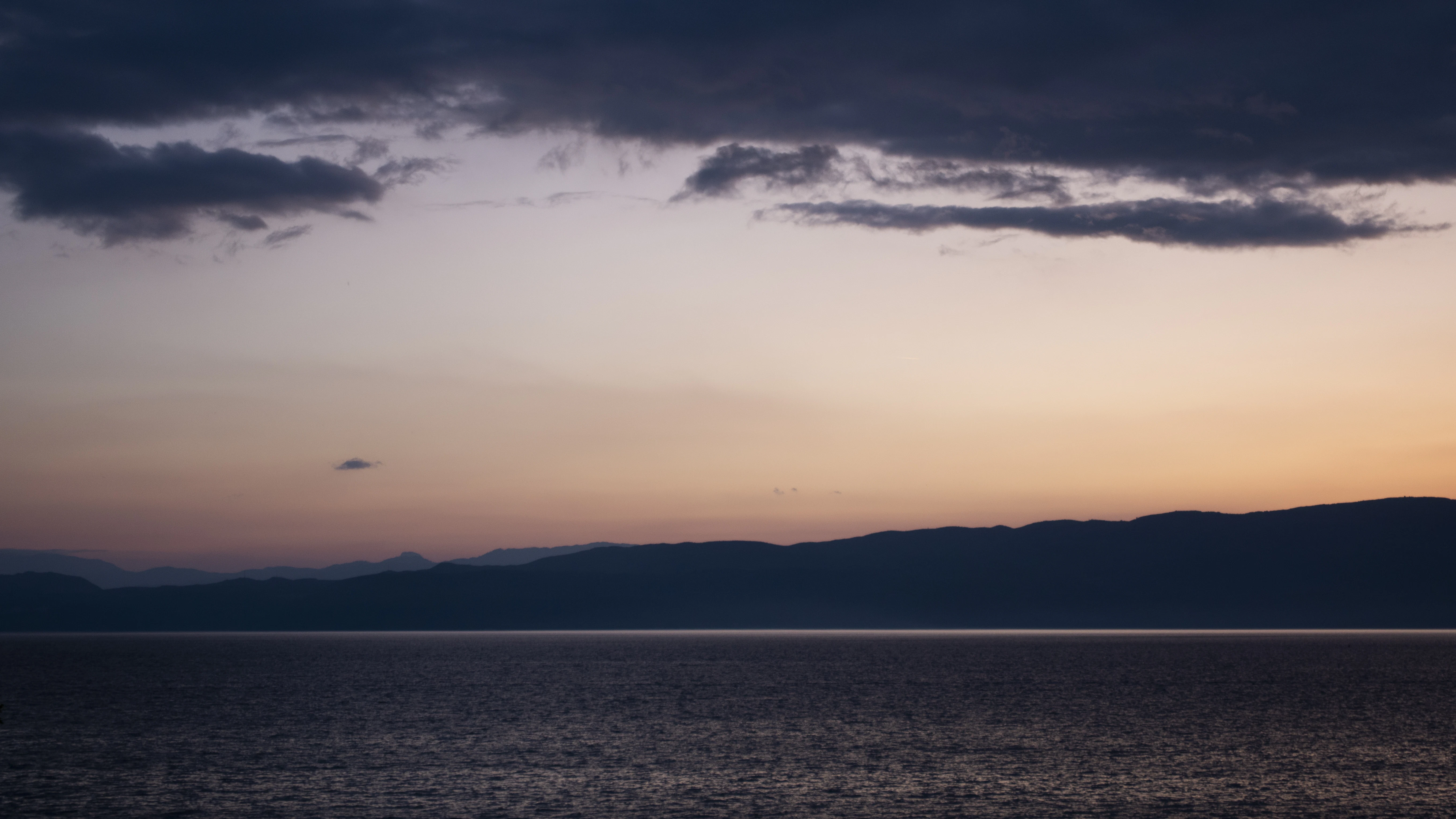 a large body of water under a cloudy sky