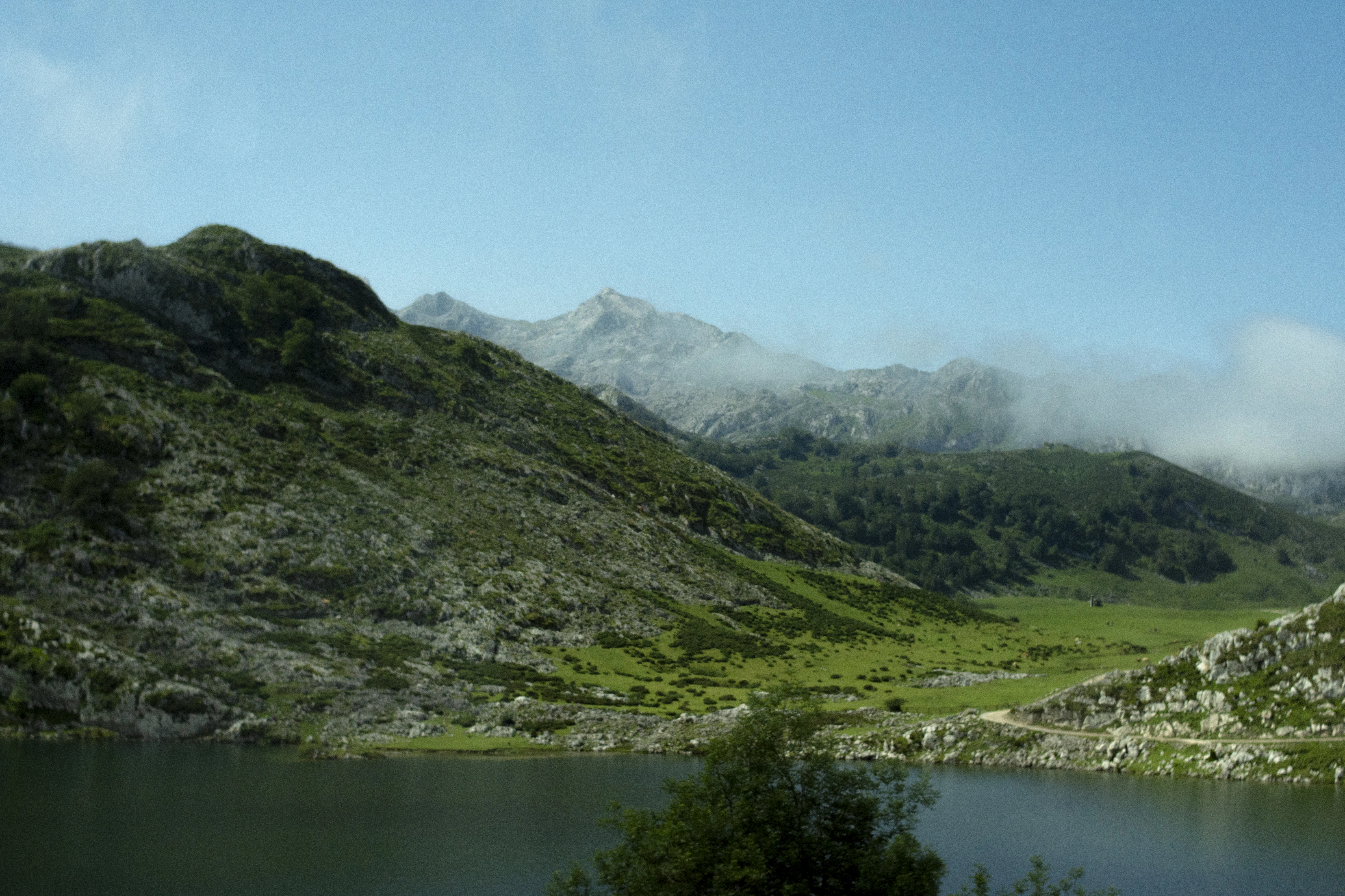 a view of a mountain range with a lake in the foreground