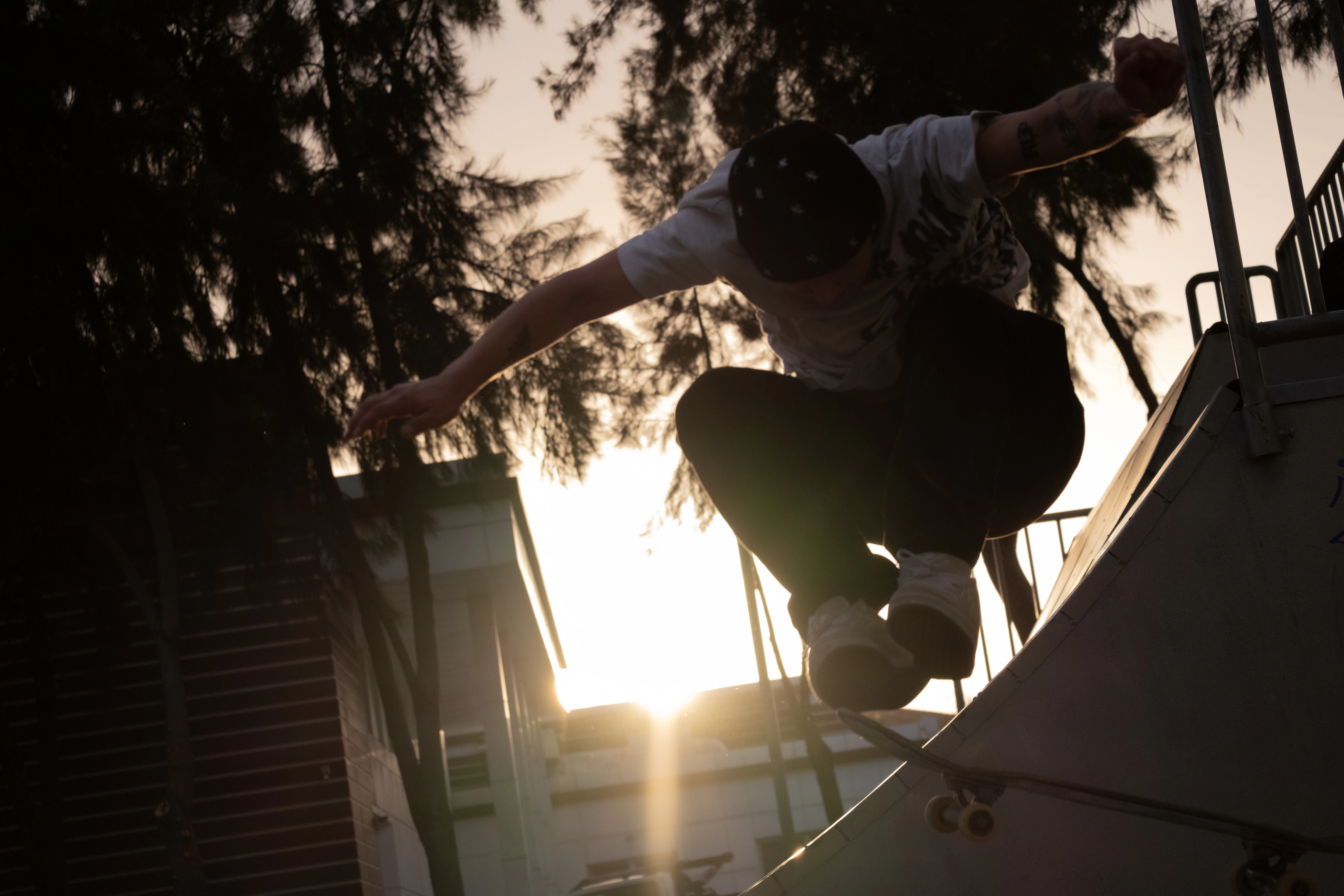 Skateboarder performing a trick at sunset