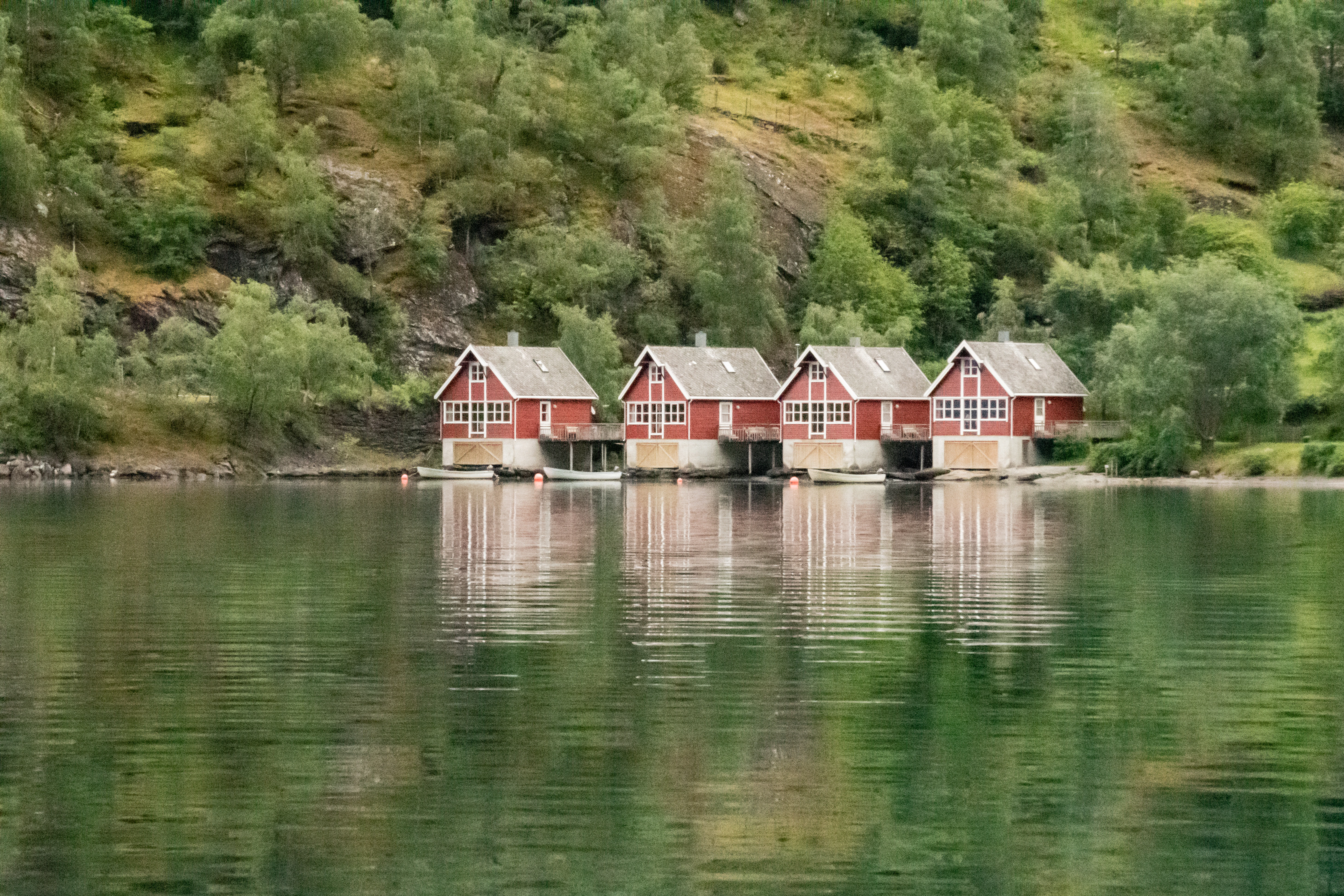 a group of red buildings by a body of water