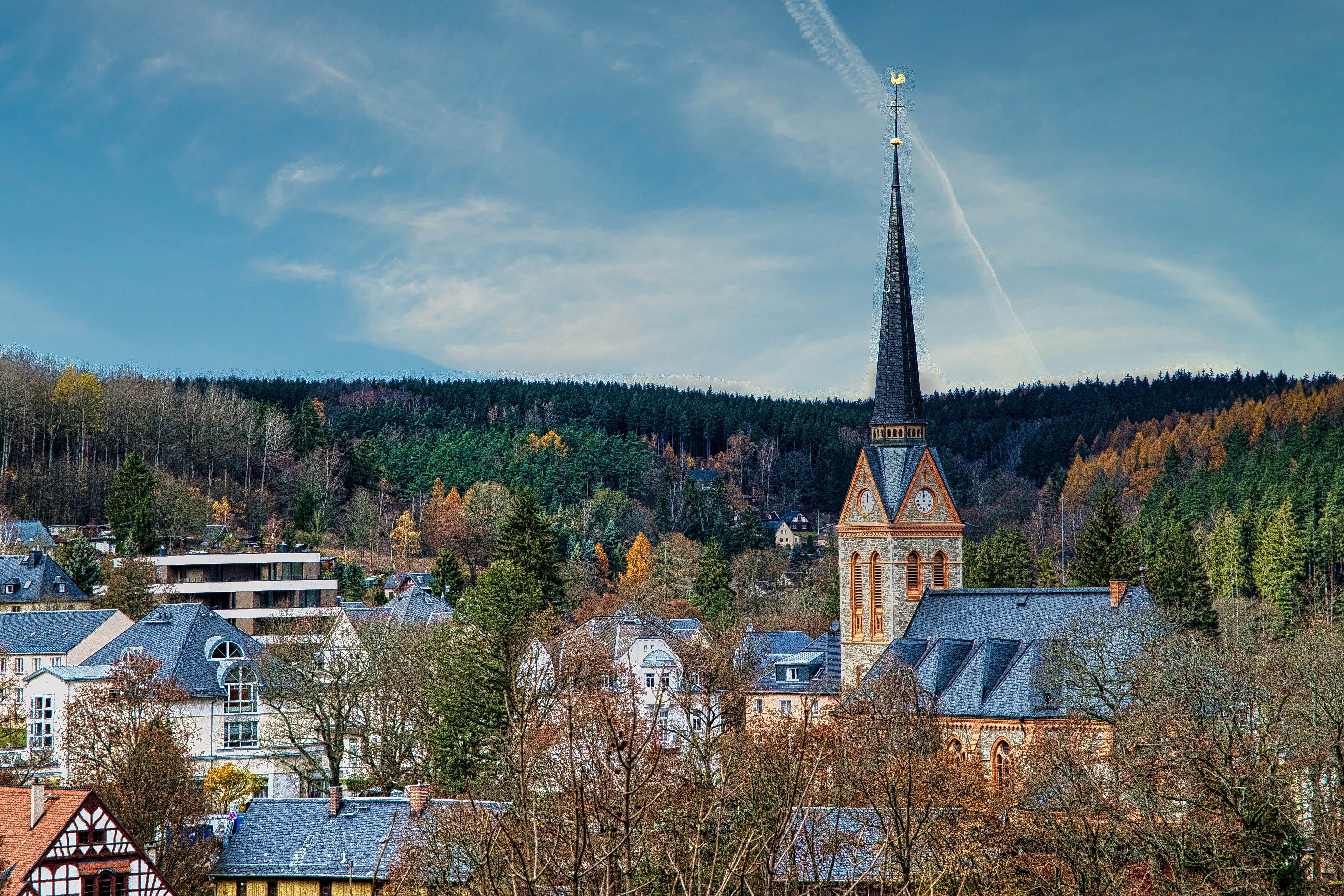 A view of a town with a church steeple in the background