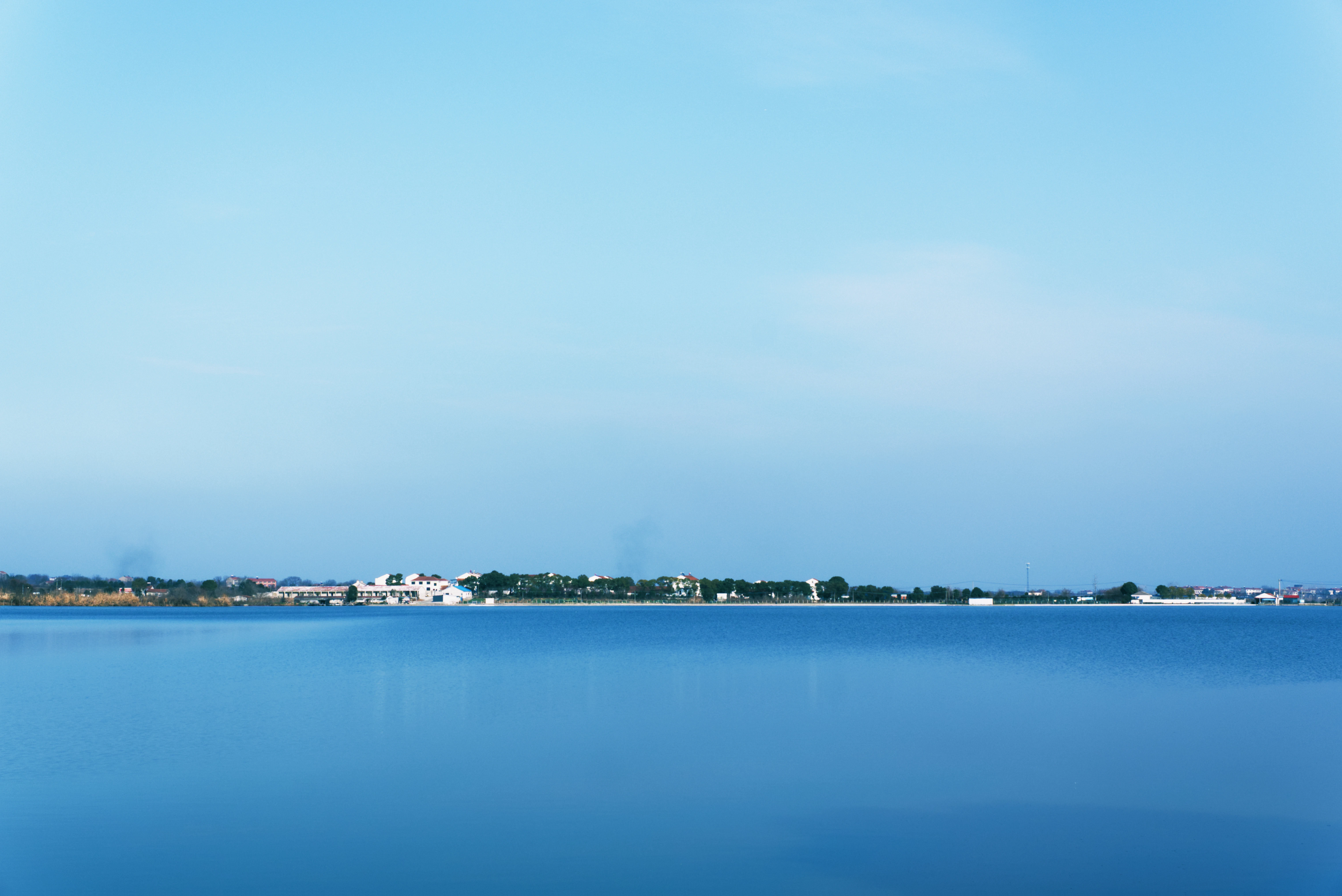 A large body of water with a sky background